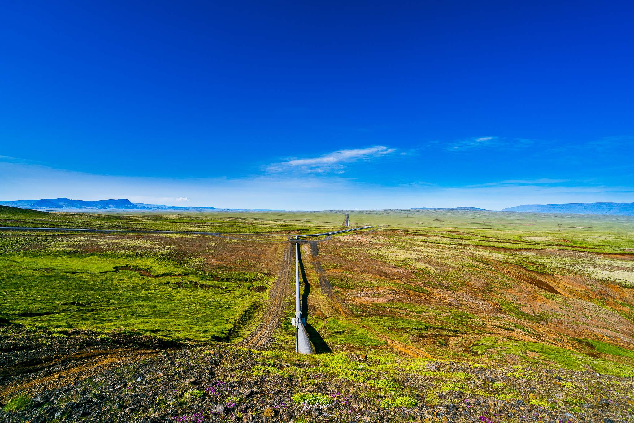 The vast space with some heat-transporting pipeline cutting through it, view from Road 435, west of Reykjavík, Iceland
