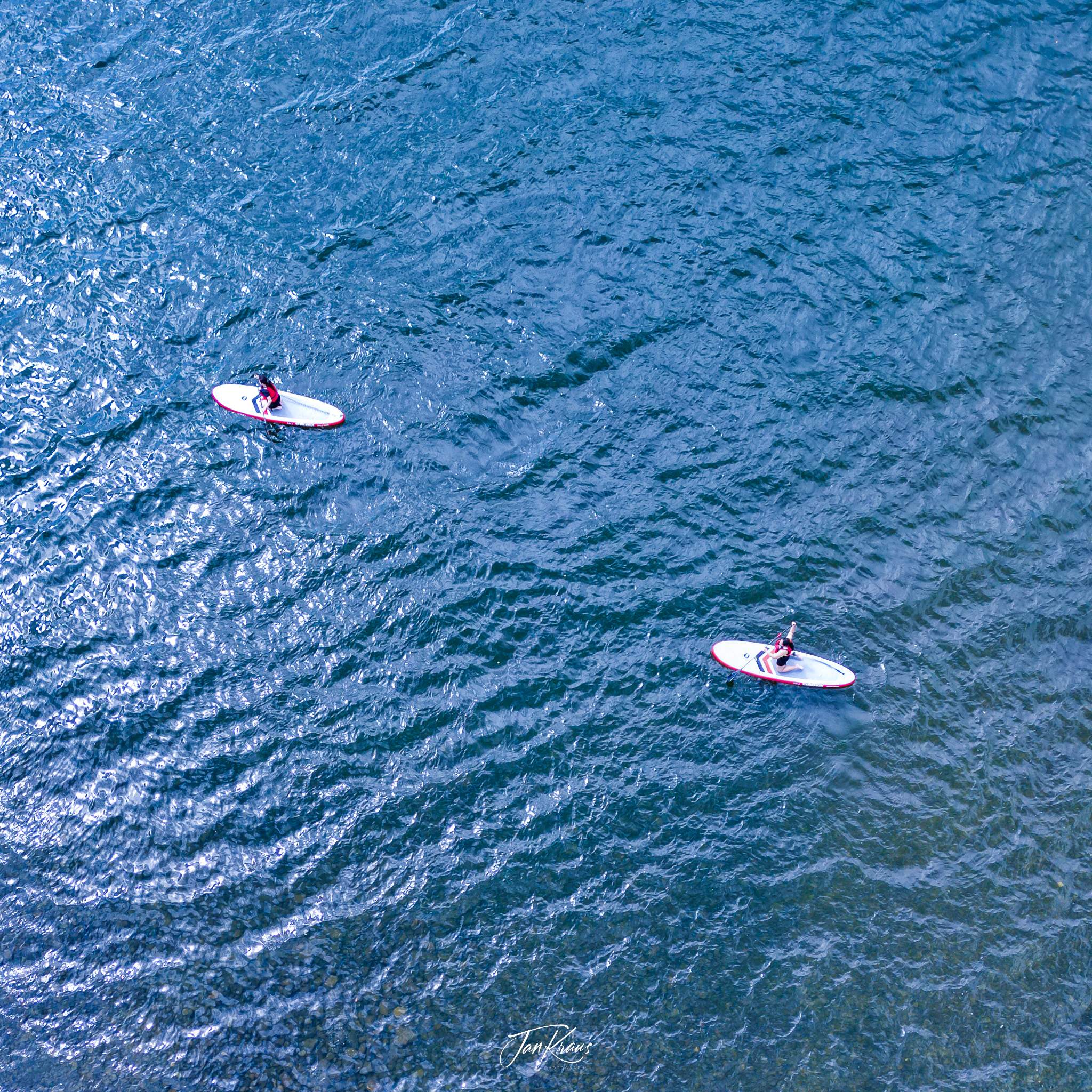 Paddle boarding at lake Windermere, Lake District, England, UK